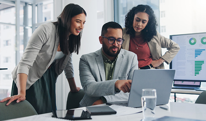 Three people looking at laptop screen
